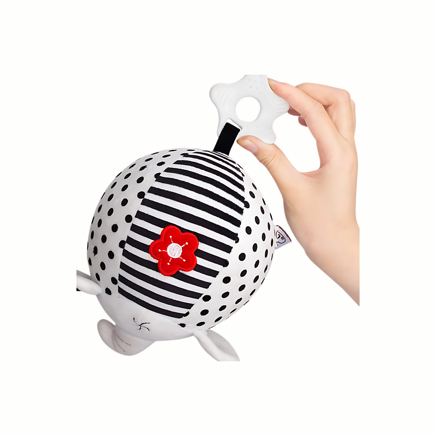 Hand holding the white textured end of the plush black and white sensory toy, showing easy grasp for baby