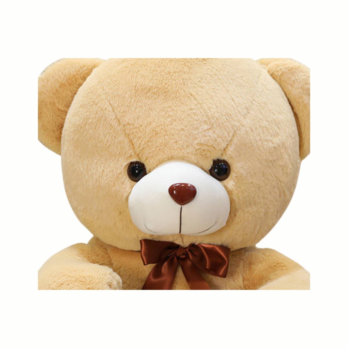 Close-up of the adorable face of the Plush Cozy Teddy Bear stuffed animal toy in beige, highlighting its gentle smile and snuggly fur.