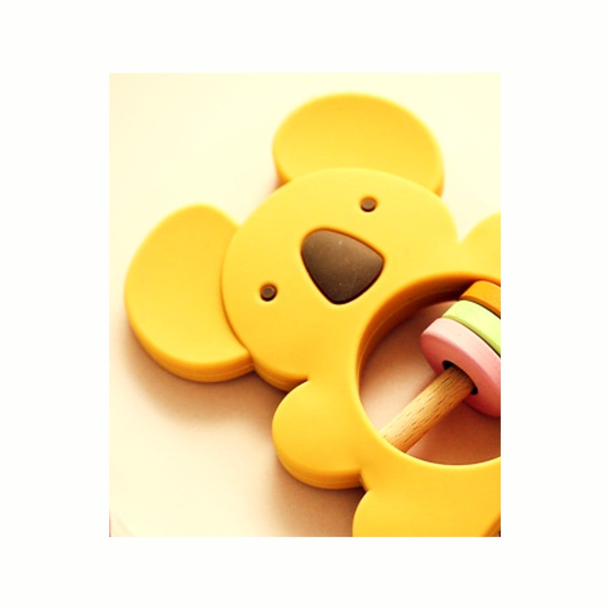 Close-up of the yellow koala Silicone Rattle Teether, showing its cute design and gentle rattle sound for auditory stimulation.