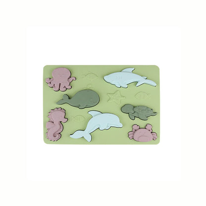 Silicone Sea Creatures Puzzle in green, showing the full set of sea animals nested into the base, promoting safe and tactile play.