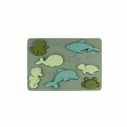 Silicone Sea Creatures Puzzle in the olive color, showing all the soft sea creatures fitted into the puzzle, an eco-conscious toy made from food-grade silicone