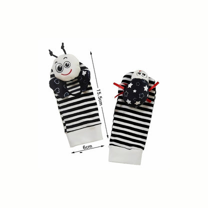 The pair of Soft Black & White Rattle Socks, made from soft fabric and designed to be easy to put on and comfortable for baby to wear.
