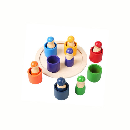 Wooden Color Matching Game with some figures placed in the cylinders and others scattered, demonstrating open-ended play and sorting possibilities.