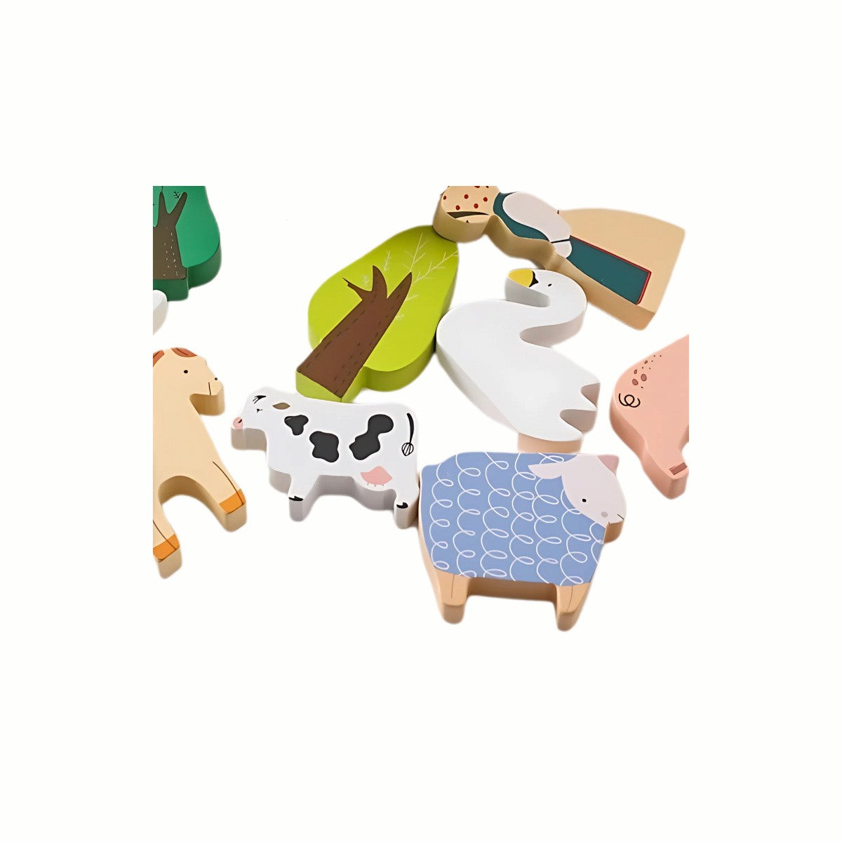 A close-up of the wooden farm-themed shapes from the Wooden Farm Balance Game, including a pig and a cow, highlighting the detail and eco-conscious toy quality.