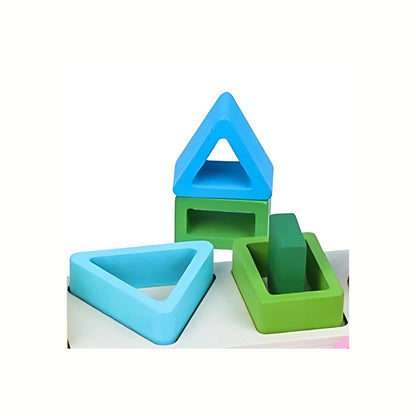 Wooden Geometric Stacking Puzzle, a close-up of the shapes stacked creatively off the board (blue triangle on green square), demonstrating its open-ended play potential.