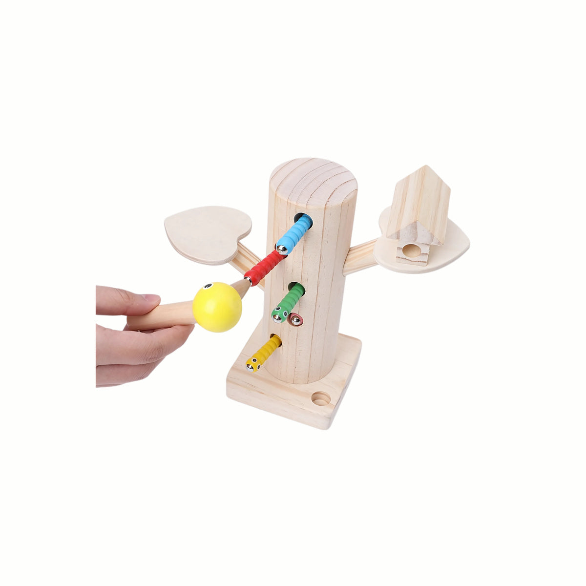 A hand holding the magnetic woodpecker figure to 'catch' a colorful worm from the tree trunk, demonstrating the action for fine motor skills and hand-eye coordination.