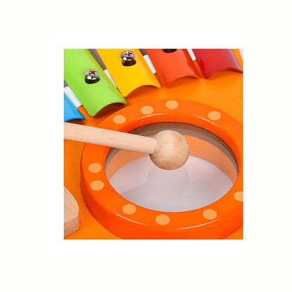 A hand tapping the rainbow-colored keys on the Wooden Rooster Xylophone with the small smiling block, emphasizing fine motor skills and sound recognition.