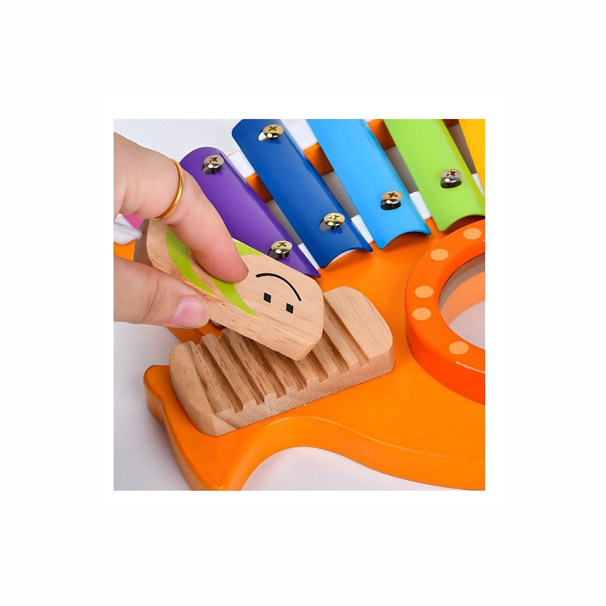 A close-up of the wooden mallet near the central mirror-like surface on the Wooden Rooster Xylophone, highlighting the safe wooden materials and engaging design.