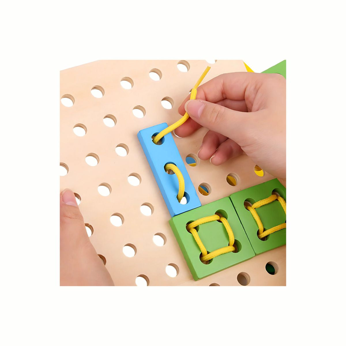 A child's hand guiding the lace through a shape on the Wooden Threading Board, demonstrating the action that develops excellent fine motor skills and dexterity.